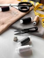 Sewing essentials. Threads, scissors, and fabric for tailoring and diy projects photo