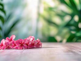 Minimalist arrangement of traditional Hawaiian lei on wooden surface featuring pink flowers photo