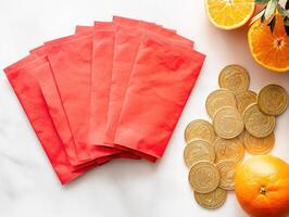 Celebratory arrangement of traditional Chinese red envelopes with oranges and coins for festive occasions photo