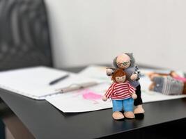 Colorful artistic dolls with sketches on desk background photo