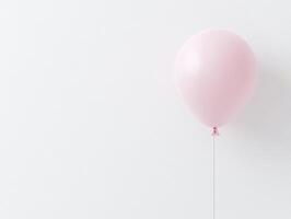 Minimalist birthday celebration with single pink balloon against white background photo
