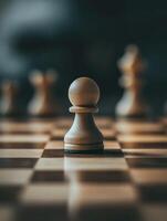 Single white chess pawn on wooden board close up for strategy concept photo