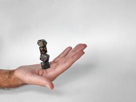 Hand balancing stacked dice. precision and skill in tabletop gaming photo