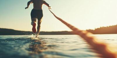 A Dynamic Athlete Skillfully Running on Water While Holding a Rope Tightly in Their Hands photo