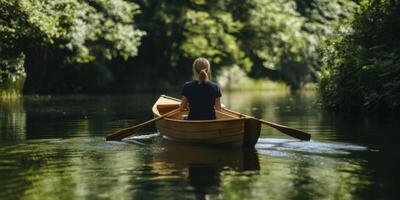 Experience the blissful serenity of rowing amidst the beautiful embrace of nature and tranquility photo