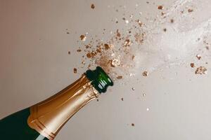 Golden champagne explosion with shimmering droplets captures a luxurious celebration moment photo