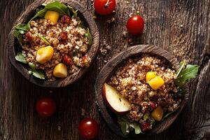Rustic quinoa salad with fresh arugula, sweet corn, roasted tomatoes, and apple slices photo