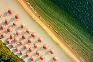Vibrant Beachside Paradise Aerial View of Pink Umbrellas and Emerald Waves photo