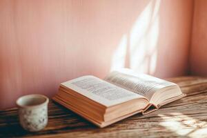Open Book on Rustic Table with Sunlit Warmth photo