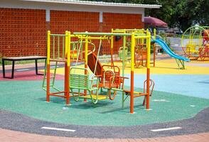 A colorful playground with slides, swings, and climbing structures, perfect for children's outdoor fun. photo