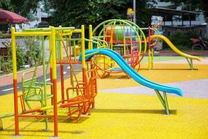 A colorful playground with slides, swings, and climbing structures, perfect for children's outdoor fun. photo