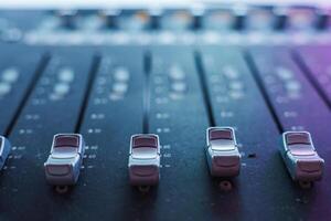 Close Up View of Audio Mixing Console with Faders in Studio photo