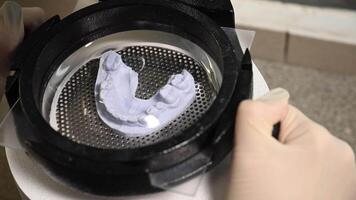 Mouth guard for teeth, printed on a 3D printer in dental clinic laboratory. 4k cinematic slow motion video