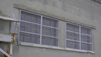 Windows of a factory closes by wire mesh video