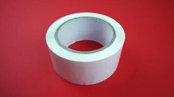 camera turns left around adhesive tape on red background video