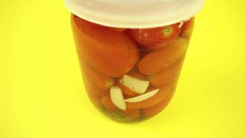 Movement around jar of closed tomatoes video