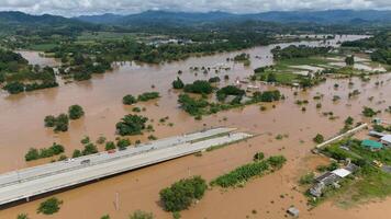 Aerial view of car stuck on the bridge after road flooded during typhoon Yagi has swept Chiang Rai province of Thailand. photo