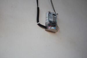 Electric Meter Installation on Wall with Protective Cover and Wiring System photo