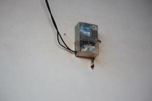 Electric Meter Installation on Wall with Protective Cover and Wiring System photo