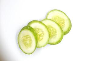 slices of fresh green cucumber. isolated white background. photo