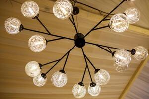 Modern loft chandelier with many shades with energy saving lamps photo