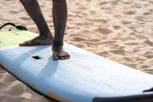 An example position of Asian professional feet on a surfboard in surfing board lesson study and training by the teacher. photo