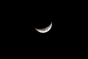 The crescent moon in the dark night sky is a beautiful and iconic sight that is often associated with mystery and magic. photo
