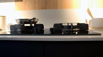 Inside the kitchen, a 2 burner gas stove with a pan set on it is being used for cooking. photo