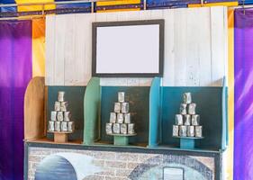 Tower of cans in front for throwing game at fun fair, Game shoot canned for outing party, Recreational pleasure. photo