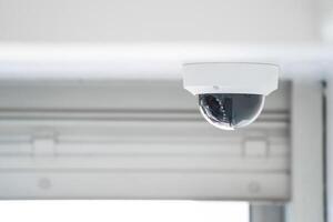 CCTV camera is installed inside the building on the ceiling and wall for monitoring and running safety system control in that area. photo
