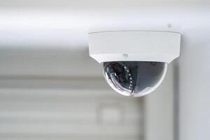 CCTV camera is installed inside the building on the ceiling and wall for monitoring and running safety system control in that area. photo