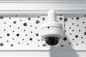 CCTV camera is installed inside the building on the ceiling and wall for monitoring and running safety system control in that area. photo