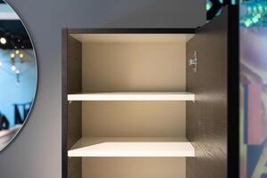 a empty black and white cabinet wood in modern and minimal style in front of wall in the restroom. photo