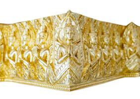 An bas-relief artwork featuring a gold colored Asian deity, located in the corner of a wall, shows the god with their hand raised as if they are praying something. photo