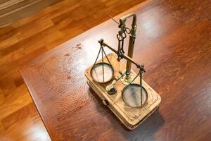 Flatlay Toptable of Classic Golden Scale in vintage mood and tone lays on wooden table. photo