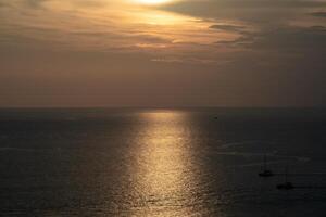 Twilight Golden time in the sea view of Phrom Thep Cape, the tropical sea sunset period, scenic point of Phuket Island, The Pearl of the Andaman Sea,Thailand popular for tourist in the world. photo