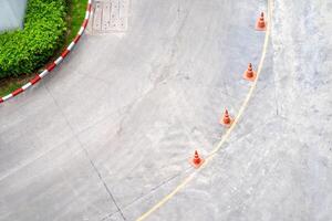Curve street from the top view angle with yellow line and traffic cone on the line. photo