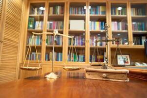 Comparison between Gold Vintage and Modern scale lay on wood table in front of library book shelf. photo
