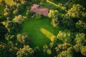 Aerial view of a house surrounded by lush greenery. photo
