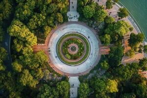 Aerial view of circular park with concentric paths, lush greenery, and people. photo