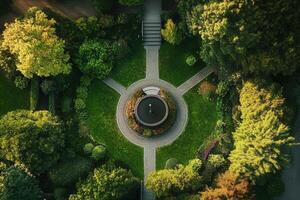 Aerial view of a circular fountain in a lush green garden. photo