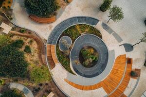 Aerial view of a circular park with benches and plants. photo
