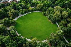 Aerial view of a lush green park with walking paths. photo