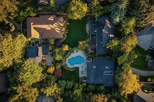 Aerial view of houses, pool, and lush greenery. photo