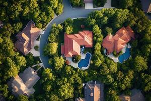 Aerial view of suburban homes, pools, and lush greenery. photo