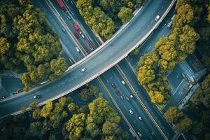 Aerial view of highway interchange surrounded by lush green trees. photo