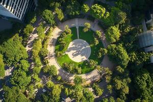 Aerial view of a circular park surrounded by trees and buildings. photo