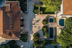 Aerial view of a symmetrical courtyard with buildings, pools, and gardens. photo