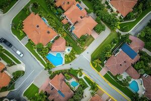 Aerial view of suburban neighborhood with houses, pools, and streets. photo
