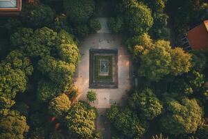 Aerial view of a square park with a central monument surrounded by lush green trees. photo